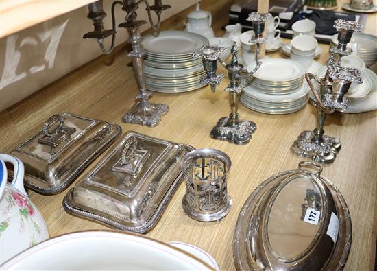 A pair of plated candelabra, a single pair of tureens, another, and an Art Nouveau bottle holder